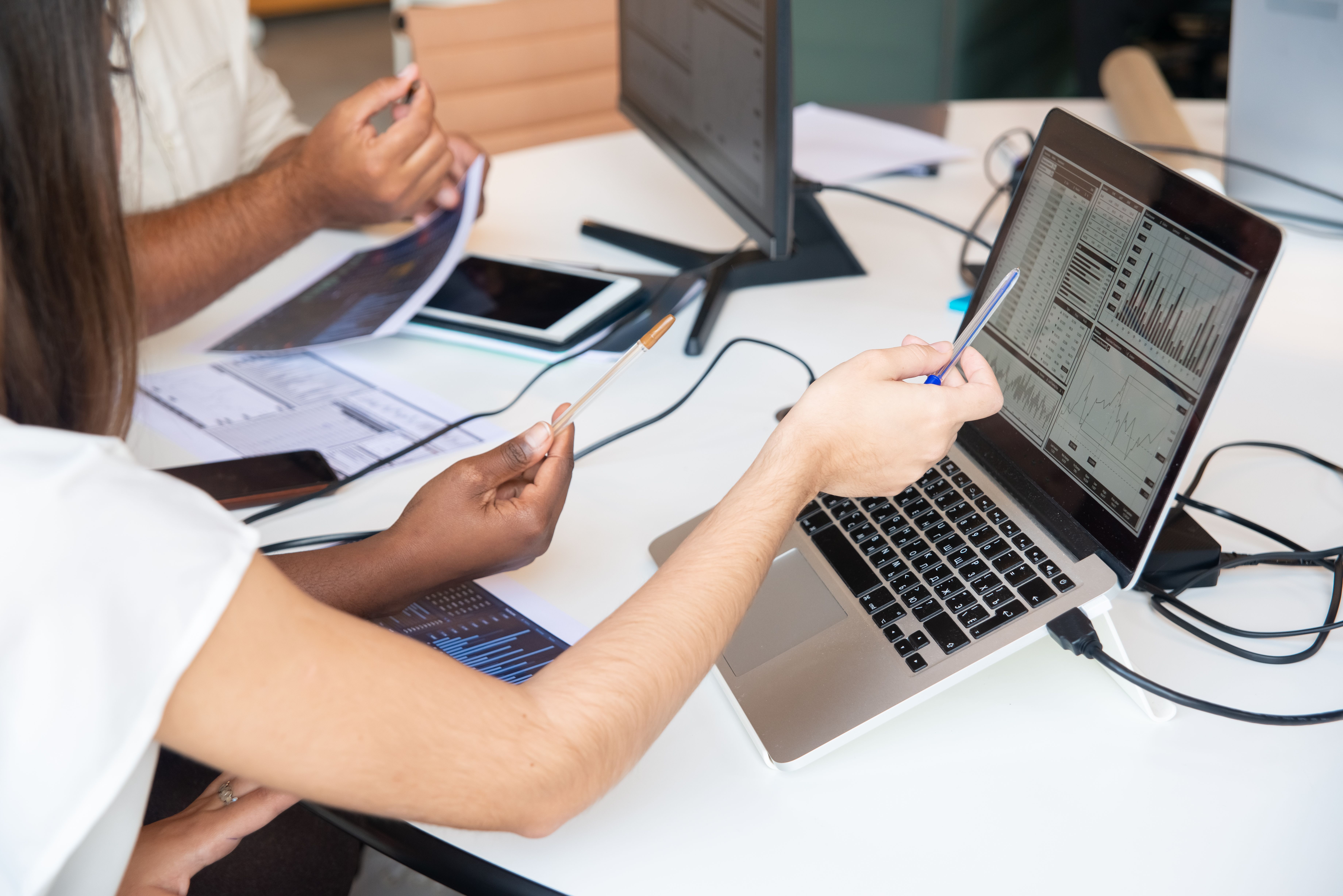 Professionals sharing practical ideas around a laptop